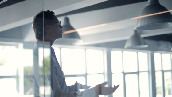 a man standing in front of a glass wall