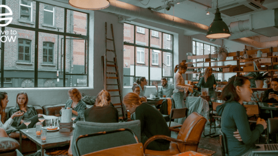 a group of people sitting at tables in a restaurant