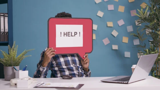 Confused Man Holding Speech Bubble To Ask For Help